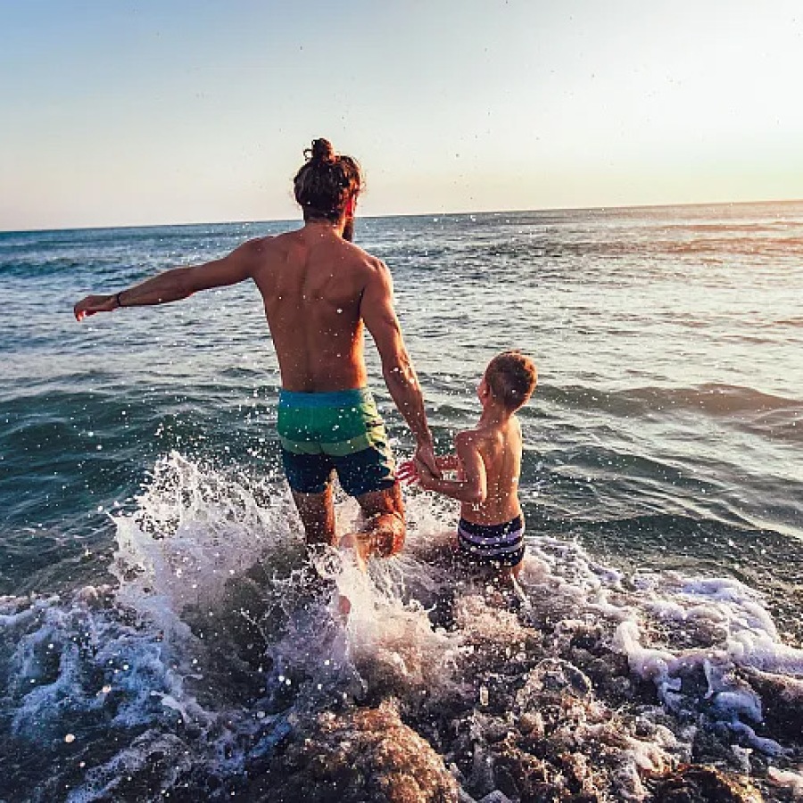 family playing on the beach